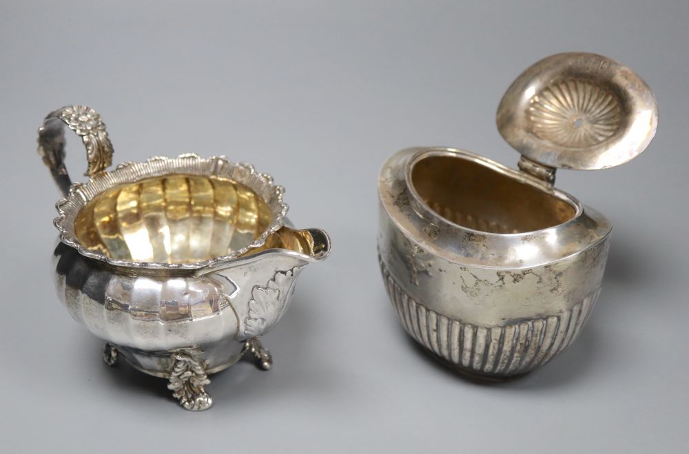 A George IV silver cream jug, London 1823 and an oval half-fluted tea caddy, approx 15oz